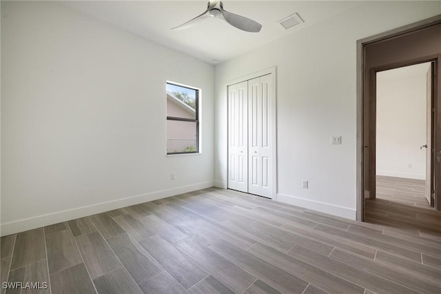 309 SW 15th Ter, Cape Coral, FL 33991 - unfurnished bedroom featuring a closet, baseboards, visible vents, and wood tiled floor