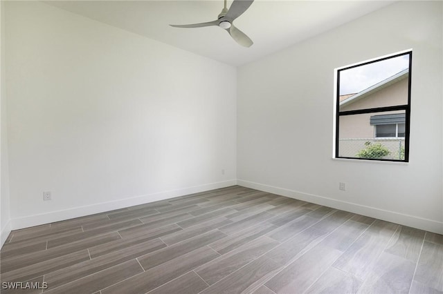 309 SW 15th Ter, Cape Coral, FL 33991 - spare room with baseboards, ceiling fan, and wood finished floors
