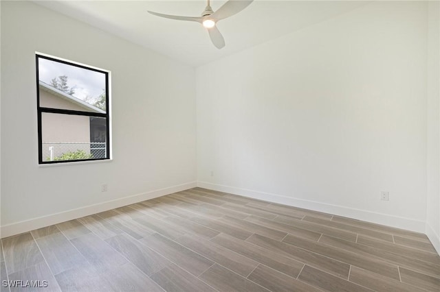 309 SW 15th Ter, Cape Coral, FL 33991 - spare room with baseboards, a ceiling fan, and wood finish floors