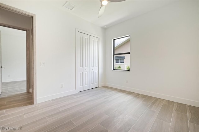309 SW 15th Ter, Cape Coral, FL 33991 - unfurnished bedroom featuring a closet, visible vents, baseboards, ceiling fan, and wood tiled floor