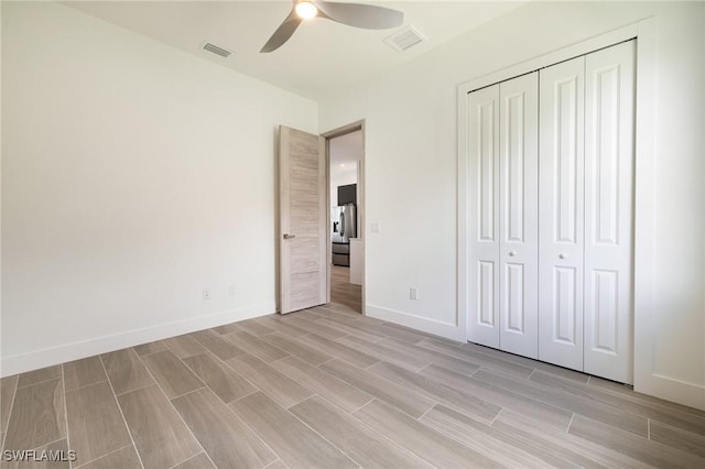 309 SW 15th Ter, Cape Coral, FL 33991 - unfurnished bedroom featuring a closet, wood tiled floor, visible vents, and baseboards