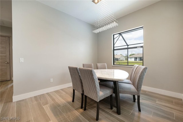 309 SW 15th Ter, Cape Coral, FL 33991 - dining room featuring an inviting chandelier, baseboards, and wood tiled floor