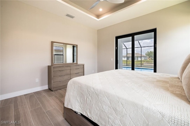 309 SW 15th Ter, Cape Coral, FL 33991 - bedroom featuring a tray ceiling, access to outside, baseboards, visible vents, and recessed lighting