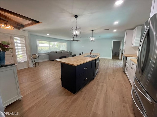 1057 Bayshore Ave, Fort Myers, FL 33919 - kitchen with baseboards, open floor plan, dark cabinets, stainless steel appliances, and butcher block countertops