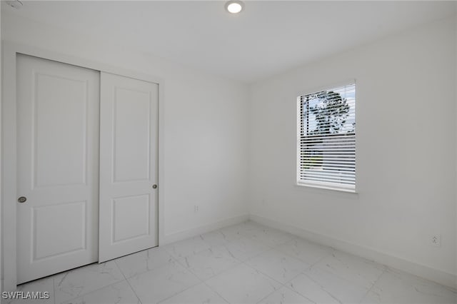 909-911 Homestead Rd S, Lehigh Acres, FL 33974 - unfurnished bedroom featuring baseboards and marble finish floor