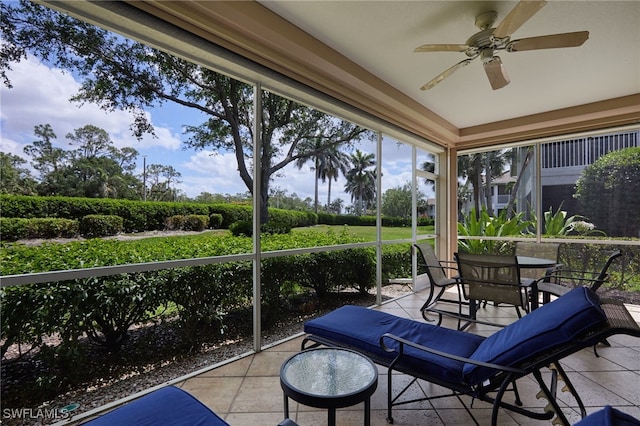 sunroom / solarium featuring outdoor dining space and a ceiling fan