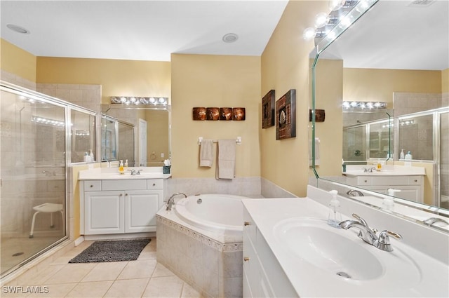 4834 Hampshire Ct Unit 207, Naples, FL 34112 - bathroom featuring a bath, a sink, two vanities, a shower stall, and tile patterned floors