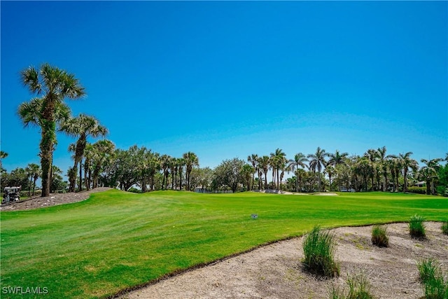 4834 Hampshire Ct Unit 207, Naples, FL 34112 - view of property's community with view of golf course and a lawn