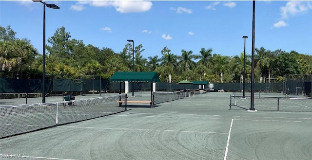 4834 Hampshire Ct Unit 207, Naples, FL 34112 - view of tennis court featuring fence