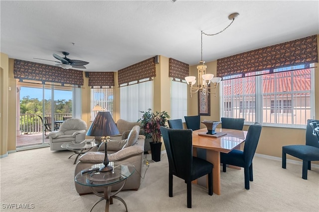 4834 Hampshire Ct Unit 207, Naples, FL 34112 - dining room featuring light carpet, ceiling fan with notable chandelier, and baseboards