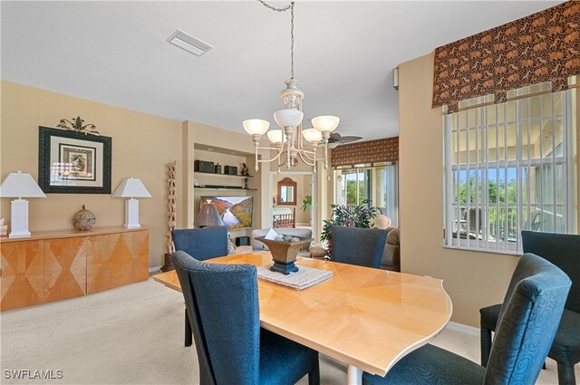 4834 Hampshire Ct Unit 207, Naples, FL 34112 - carpeted dining area featuring an inviting chandelier and visible vents