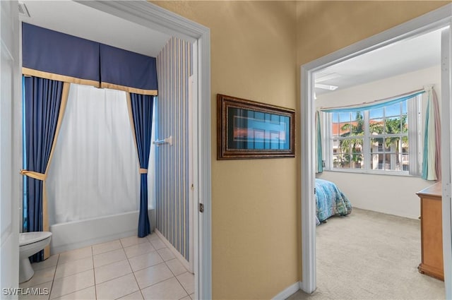 4834 Hampshire Ct Unit 207, Naples, FL 34112 - ensuite bathroom featuring toilet, shower / tub combo, connected bathroom, and tile patterned floors