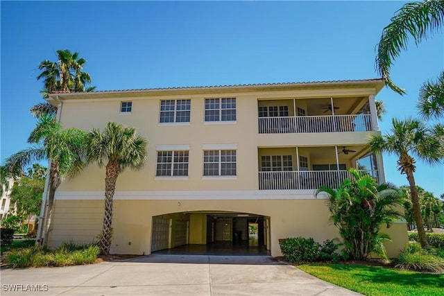4834 Hampshire Ct Unit 207, Naples, FL 34112 - view of property with a carport and driveway