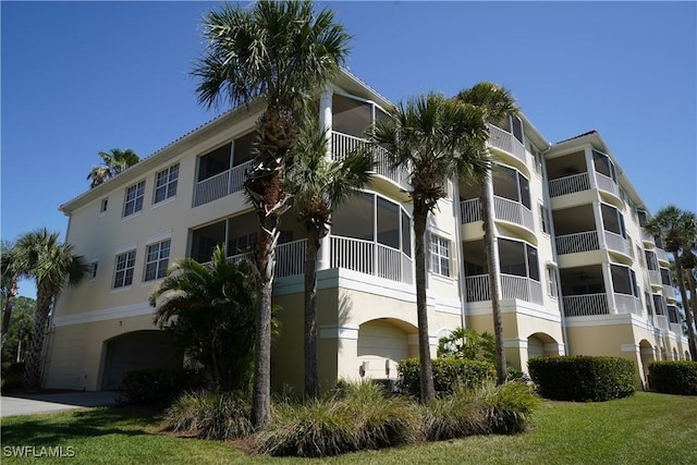 4834 Hampshire Ct Unit 207, Naples, FL 34112 - view of property featuring a garage