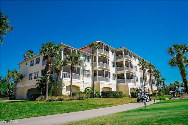 4834 Hampshire Ct Unit 207, Naples, FL 34112 - view of building exterior with an attached garage