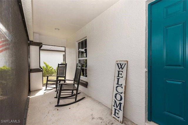 3009 35th St SW, Lehigh Acres, FL 33976 - view of exterior entry with a porch and stucco siding