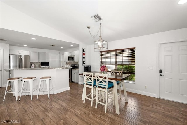 3009 35th St SW, Lehigh Acres, FL 33976 - dining space featuring dark wood-style flooring, visible vents, a notable chandelier, lofted ceiling, and recessed lighting