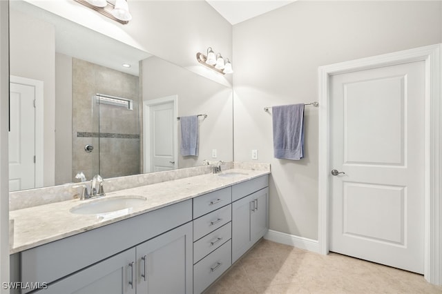 1408 Lucena Ln S, Naples, FL 34113 - full bathroom featuring a tile shower, baseboards, a sink, and double vanity