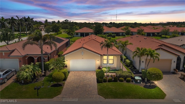 1408 Lucena Ln S, Naples, FL 34113 - mediterranean / spanish-style house with a garage, stucco siding, a tiled roof, and decorative driveway