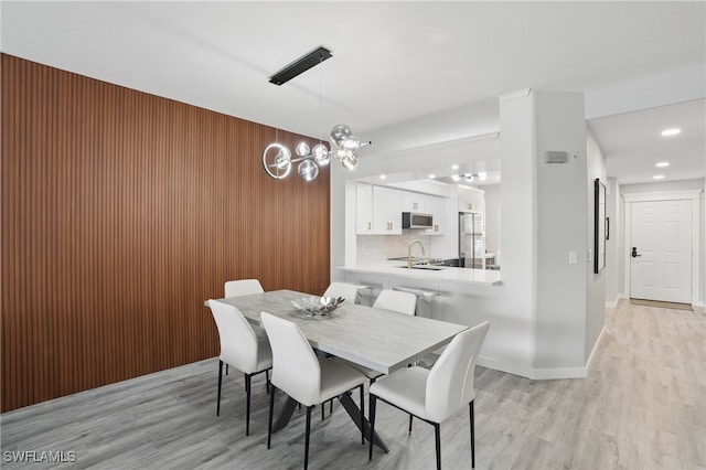 1220 Sarah Jean Cir Unit L103, Naples, FL 34110 - dining area featuring light wood-style floors, recessed lighting, a chandelier, and baseboards