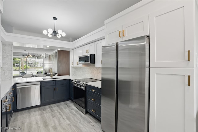 1220 Sarah Jean Cir Unit L103, Naples, FL 34110 - kitchen featuring appliances with stainless steel finishes, a sink, light countertops, tasteful backsplash, and a chandelier