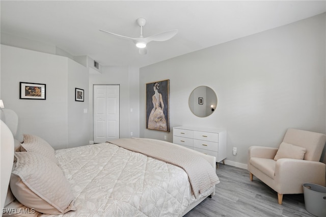 1220 Sarah Jean Cir Unit L103, Naples, FL 34110 - bedroom with light wood-style flooring, a closet, a ceiling fan, and baseboards