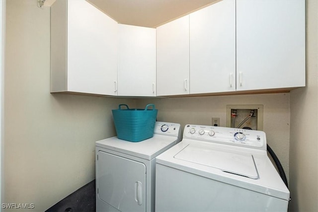 washroom featuring cabinet space and washing machine and dryer