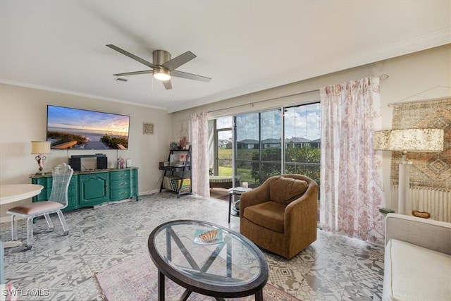 sitting room featuring visible vents, baseboards, ornamental molding, ceiling fan, and light carpet