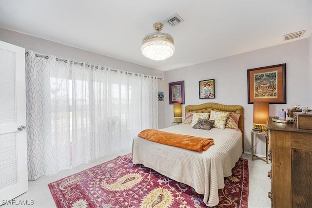 bedroom with visible vents and carpet flooring