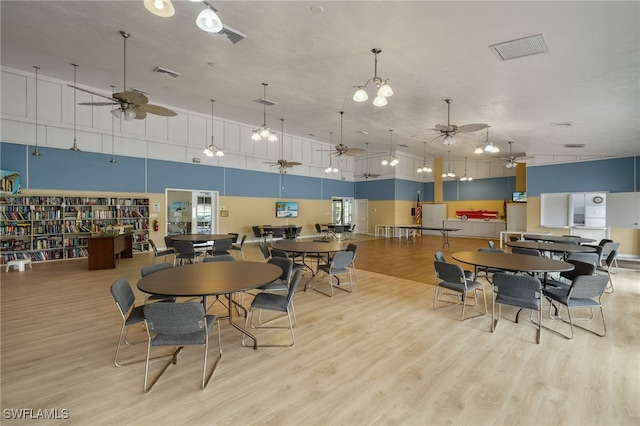 dining area featuring visible vents, ceiling fan, and wood finished floors