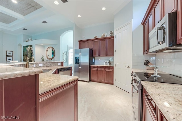 7699 Cottesmore Dr, Naples, FL 34113 - kitchen with backsplash, crown molding, appliances with stainless steel finishes, arched walkways, and a sink