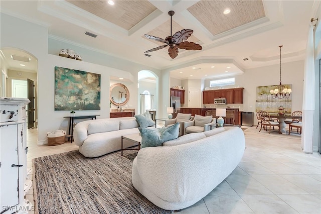 7699 Cottesmore Dr, Naples, FL 34113 - living room featuring crown molding, recessed lighting, arched walkways, coffered ceiling, and light tile patterned floors