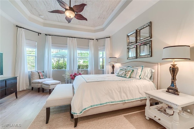 7699 Cottesmore Dr, Naples, FL 34113 - bedroom featuring light wood-style floors, crown molding, a ceiling fan, and a tray ceiling