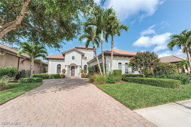 7699 Cottesmore Dr, Naples, FL 34113 - mediterranean / spanish-style home with decorative driveway, stucco siding, and a tiled roof
