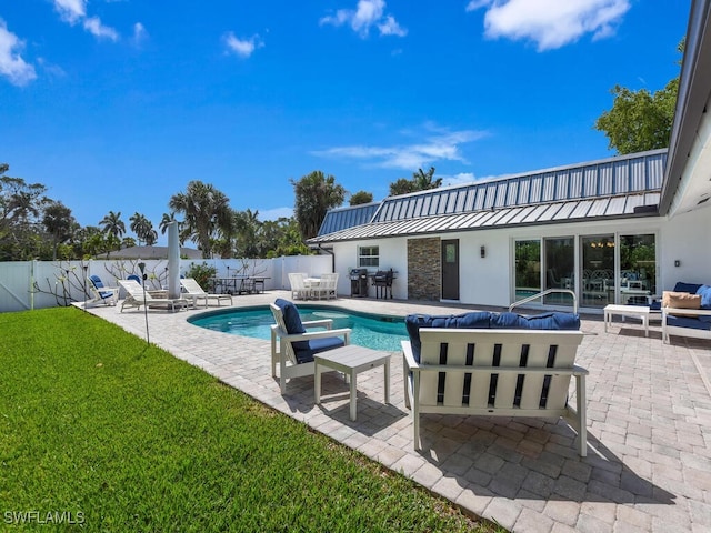 view of pool with a lawn, a patio area, fence, and a fenced in pool