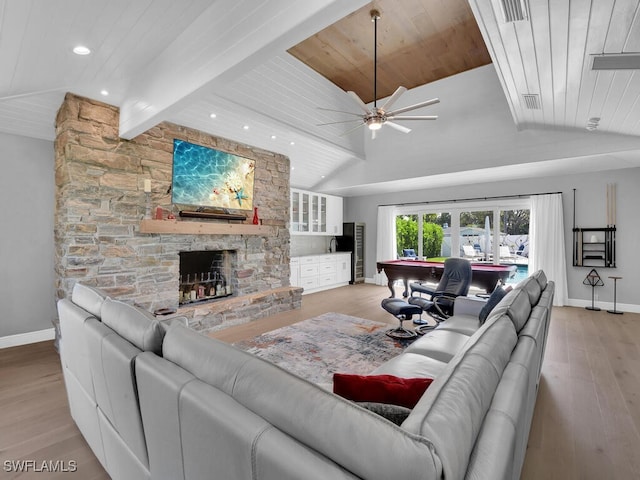 living room featuring baseboards, vaulted ceiling, wooden ceiling, and light wood-style floors