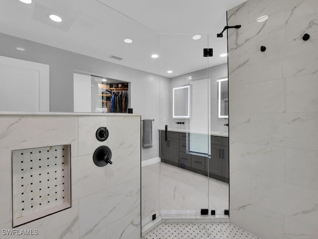 full bathroom with a walk in closet, visible vents, vanity, recessed lighting, and tiled shower