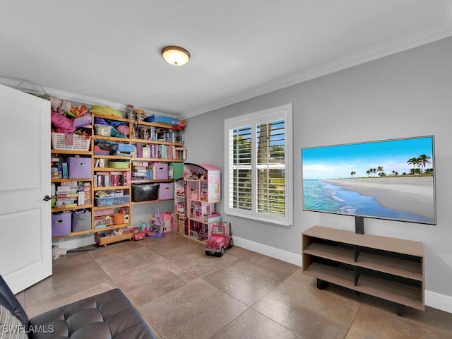 playroom featuring crown molding and baseboards