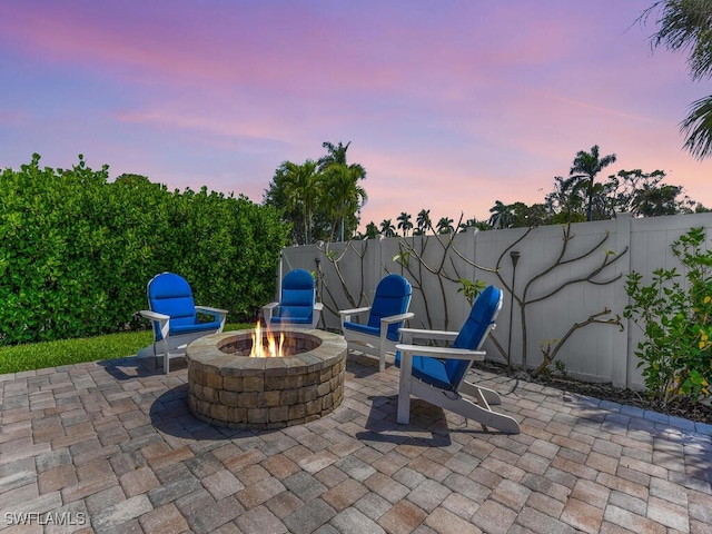 view of patio with an outdoor fire pit and fence