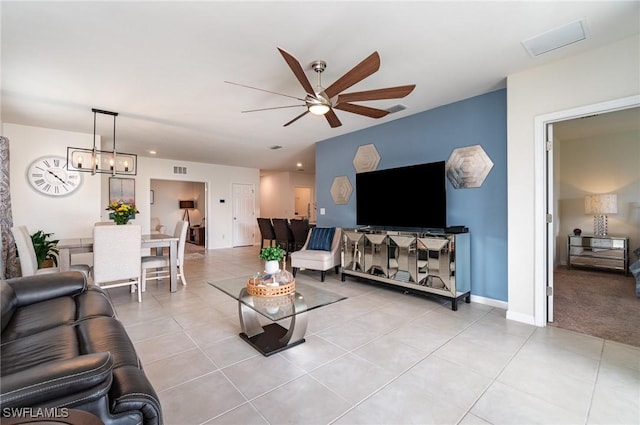 20018 Fiddlewood Ave, North Fort Myers, FL 33917 - living area featuring ceiling fan, light tile patterned floors, and a chandelier