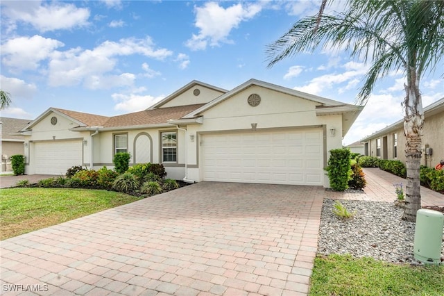 20018 Fiddlewood Ave, North Fort Myers, FL 33917 - single story home featuring stucco siding, a garage, decorative driveway, and a front lawn