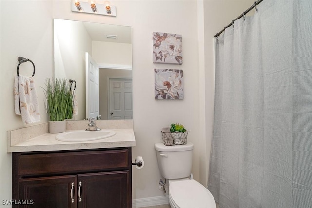 bathroom with toilet and vanity