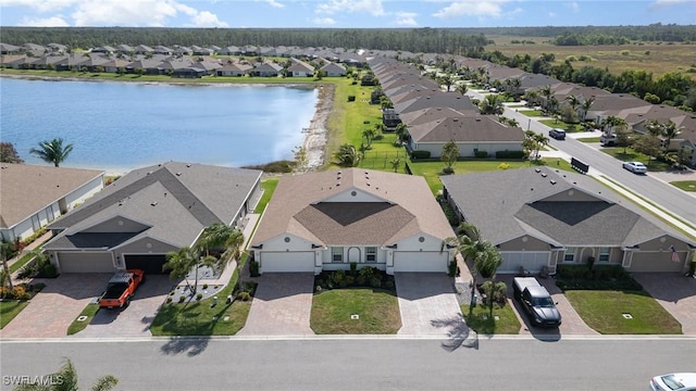 aerial view of residential area featuring a nearby body of water