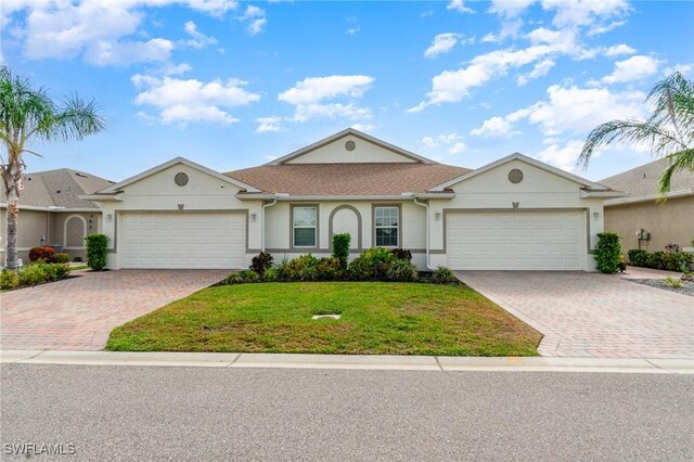 20018 Fiddlewood Ave, North Fort Myers, FL 33917 - ranch-style home with a garage, stucco siding, and decorative driveway