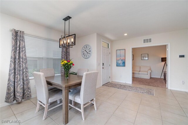 dining space with a chandelier, light tile patterned floors, recessed lighting, and baseboards