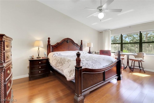 3207 Horse Carriage Way Unit 406, Naples, FL 34105 - bedroom with vaulted ceiling, wood finished floors, and baseboards