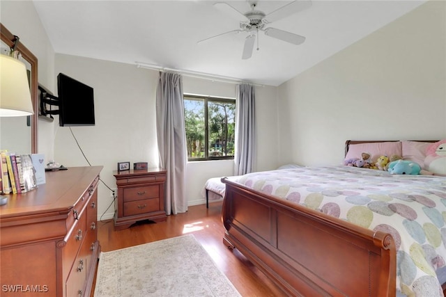 3207 Horse Carriage Way Unit 406, Naples, FL 34105 - bedroom with baseboards, light wood-style flooring, and a ceiling fan