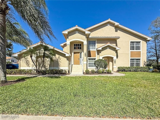 14641 Glen Cove Dr Unit 1704, Fort Myers, FL 33919 - view of front of home with stucco siding and a front yard