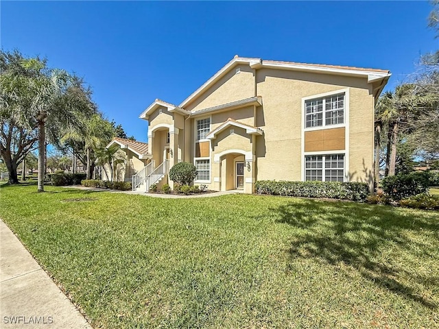 14641 Glen Cove Dr Unit 1704, Fort Myers, FL 33919 - view of front of property featuring a front yard and stucco siding