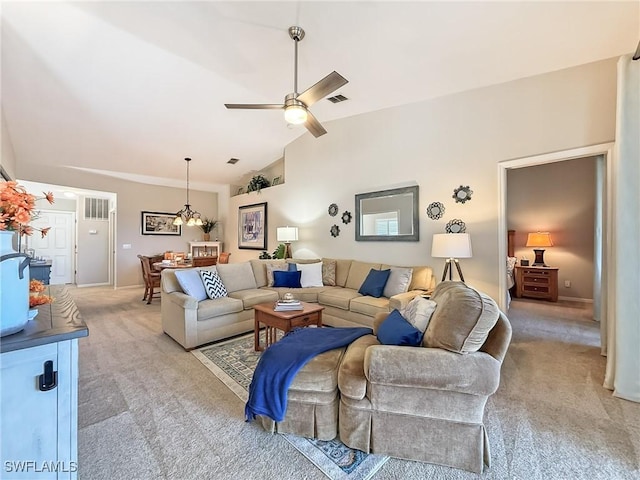 14641 Glen Cove Dr Unit 1704, Fort Myers, FL 33919 - living area with high vaulted ceiling, light carpet, ceiling fan with notable chandelier, and visible vents